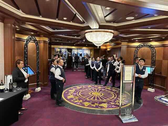 Main dining room on RCCL with a group of waiters waiting