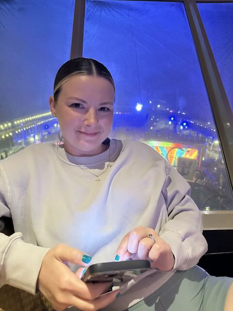Britini in a cozy outfit in the lounge on royal caribbean cruise ship with Jim Mercer