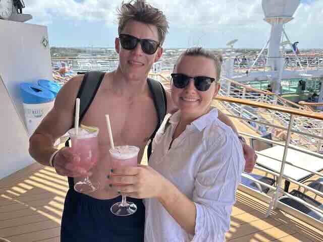 Family spending time together on a cruise ship with alcoholic drinks man and woman holding drinks together happy cruise