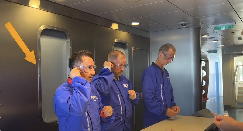 3 guys getting ready to go skydiving on royal caribbean cruise ship