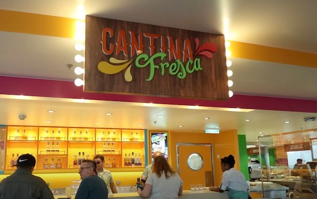 Star of the Seas Cantina Fresca sign with lights on it and people at the bar