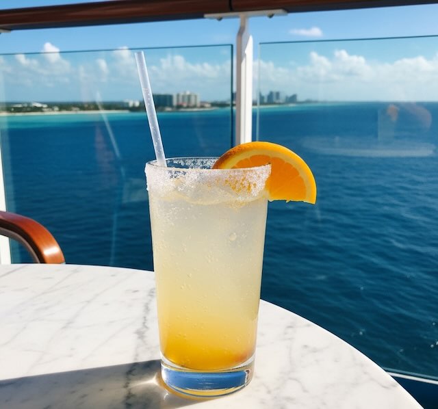 Sugary drink on Royal caribbean cruise with water in background and orange in drink yum