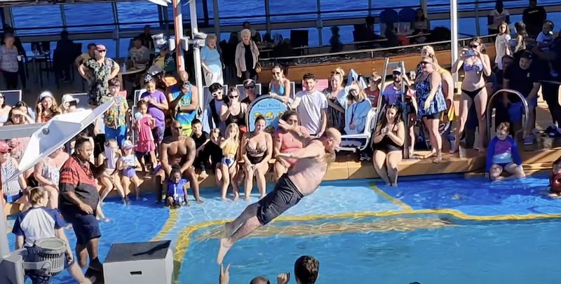 Overview of Vision of the Seas & Cabins - man jumping in the pool on vision of the seas