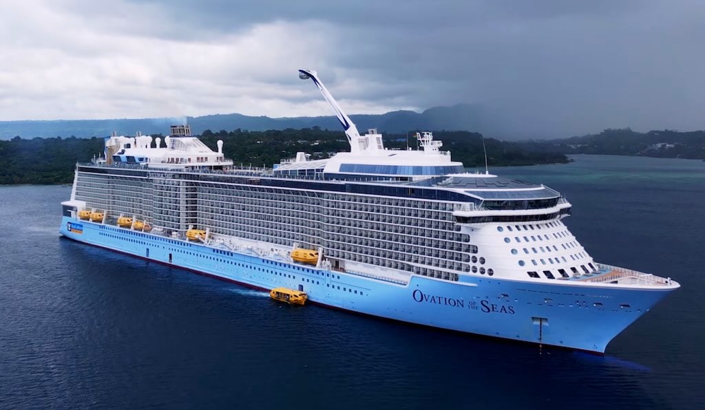 Ovation of the Seas anchored with island in background