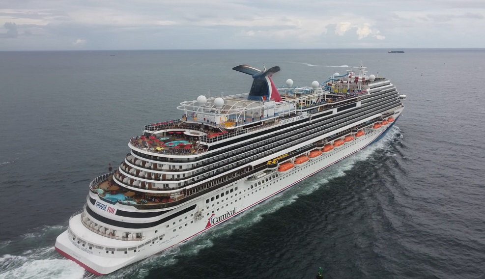 Aerial drone view of Carnival Horizon cruising at sea during a vibrant celebration.