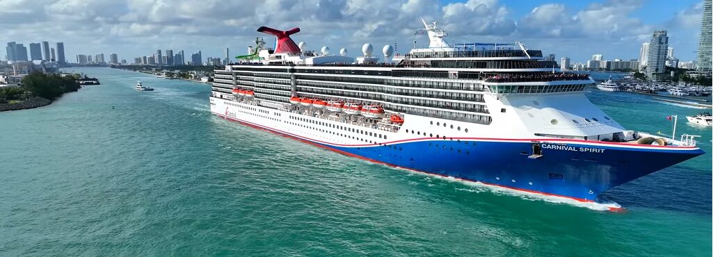 Aerial drone view of Carnival Spirit cruising at sea during a vibrant celebration