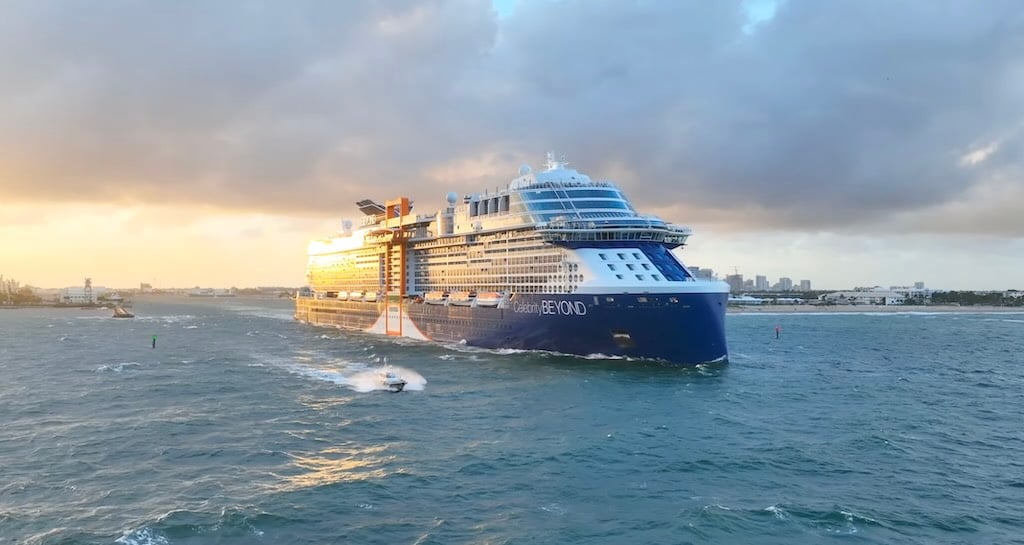 Celebrity Beyond cruise ship sailing at sea near port at sunset
