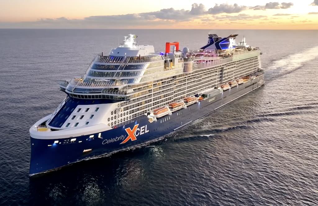 Celebrity Xcel cruise ship sailing at sea during sunset