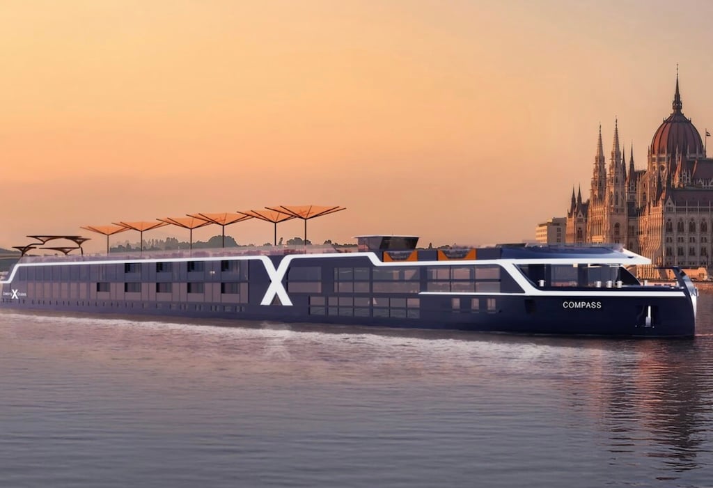 Celebrity river cruise ship with beautiful city in background