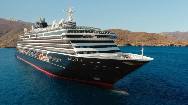 Explora II review image showing the luxury cruise ship near a rocky coast